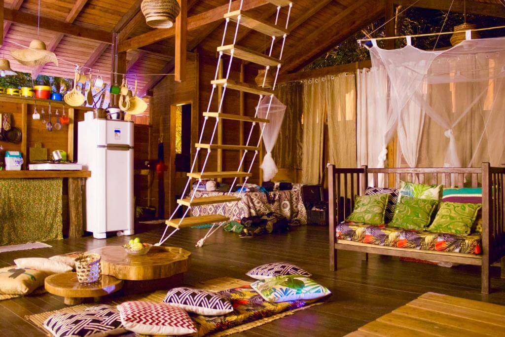 Cômodo da Casa da Árvore em Alter do Chão no Pará com cozinhas, camas, redes e travesseiros